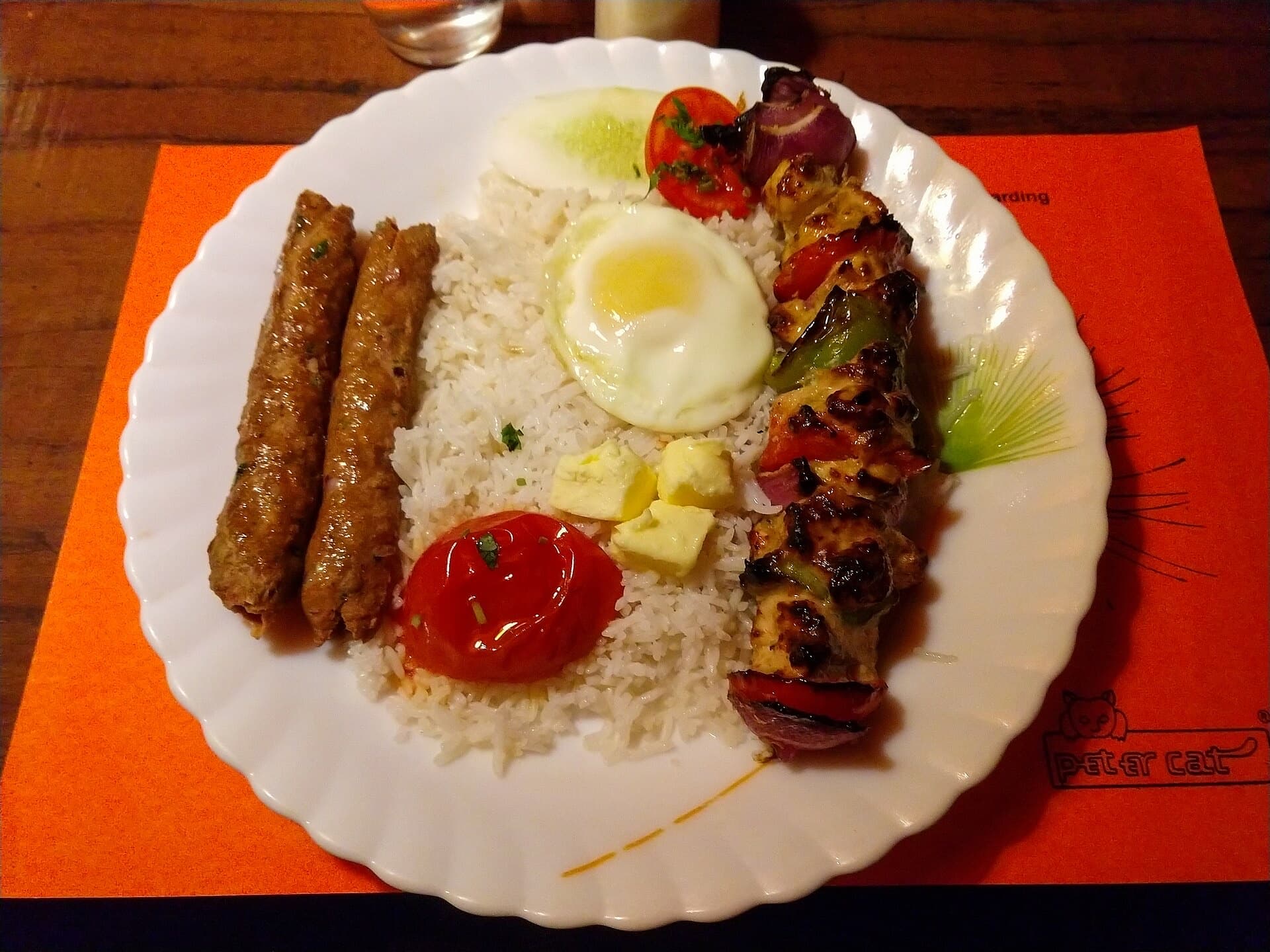 Chelo kebab at Peter Cat: buttered rice, a fried egg, a seekh and a chicken kebab