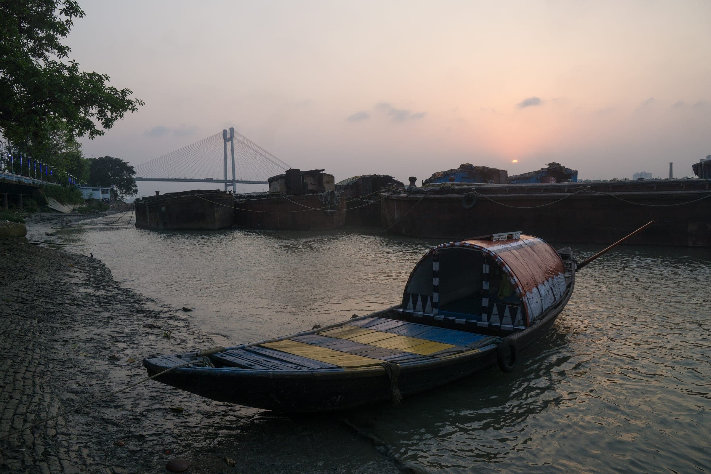 A country boat on the Hooghly at sunset, Vidyasagar Setu behind