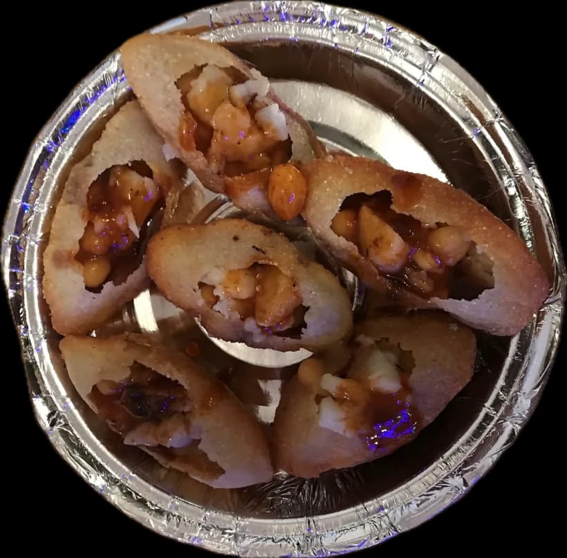 Phuchka filled with potato in a foil bowl