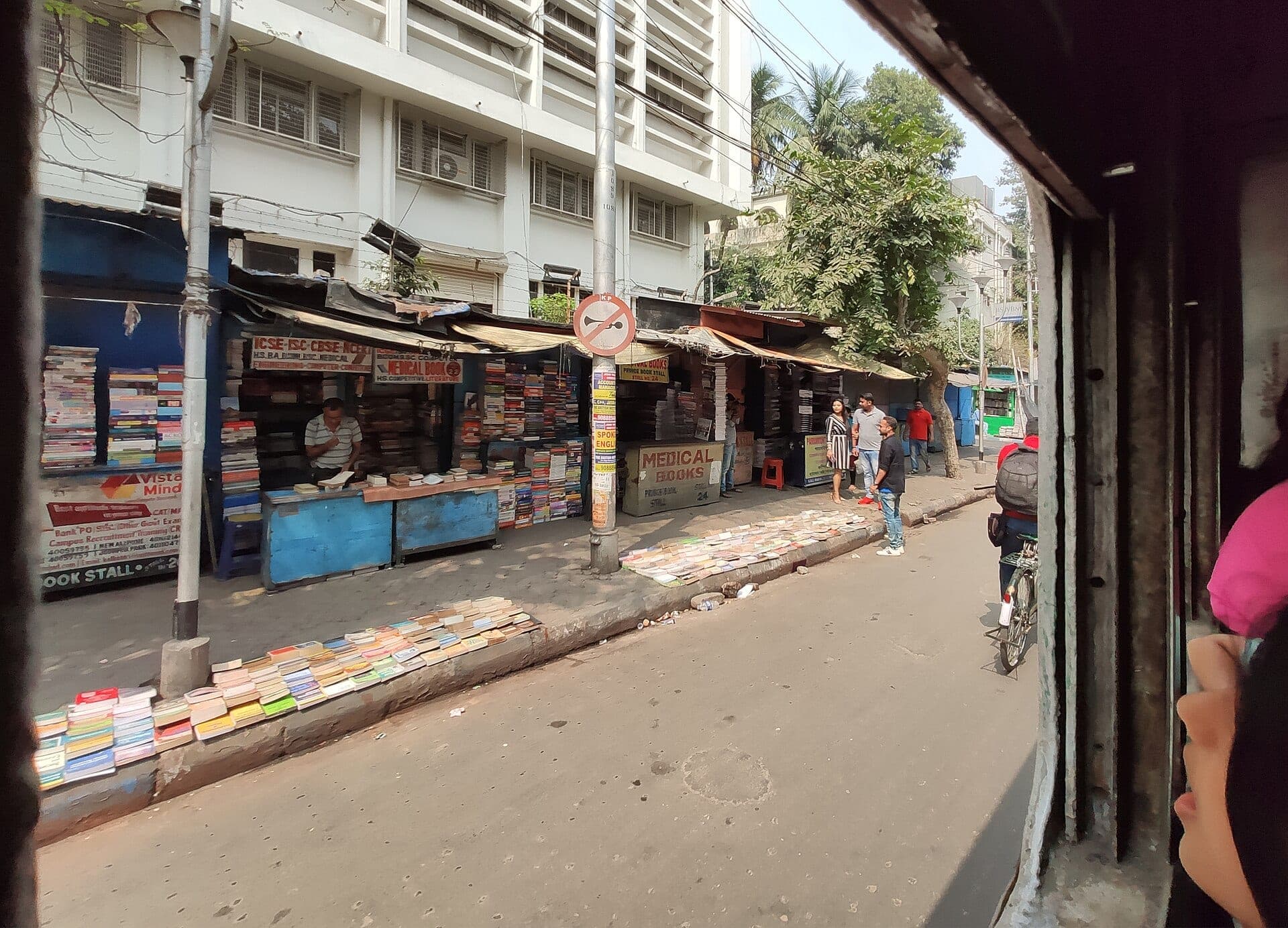 Book stalls on College Street, seen from a tram window