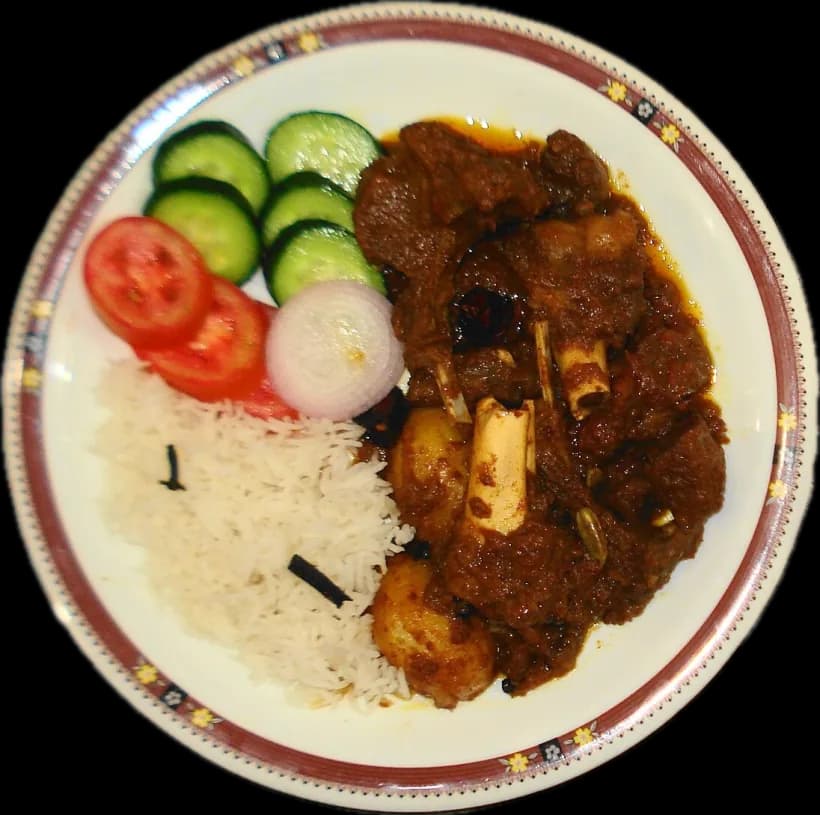 Kosha mangsho on a plate with rice and salad