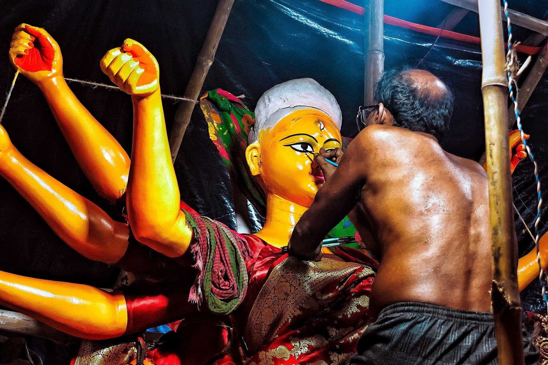 An artisan painting a Durga idol in Kumartuli